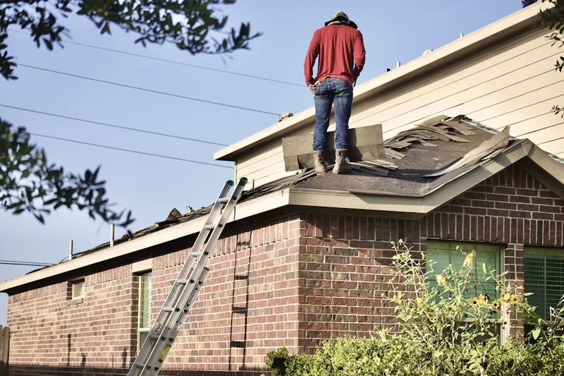 Professional roofer working on a residential roof in McLean